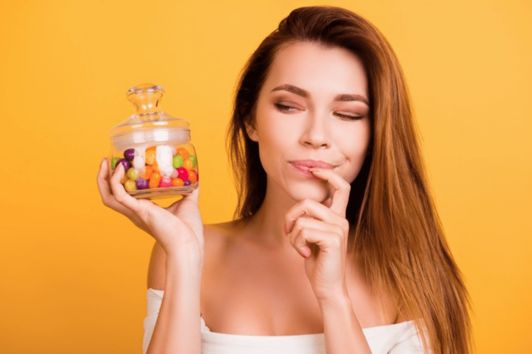 Woman Holding A Jar Of Candies